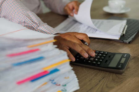 Businessman manager hands writing signing in paperwork or documentation documents on office deskの写真素材