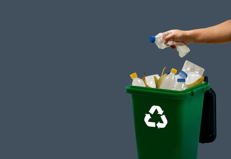 person hand holding garbage bag bag in to trash dump food environment city green background bio...