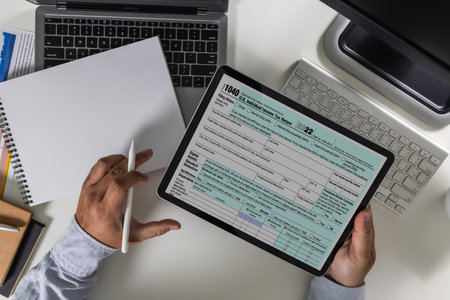 Financial time tax form with laptop Accounting documents, office paperwork, refunds, and investment taxation report analysis and calculation onlineの写真素材