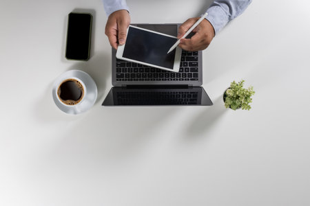 person designer computer laptop datum document research chart finance marketing Working on a white desk in an office workplace view overhead modern space flat layの写真素材