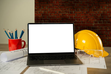 architect engineers Working on a desktop computer on a laptop mockup screen with an architectural project and blueprint on a desk working equipment industrial constructionの写真素材