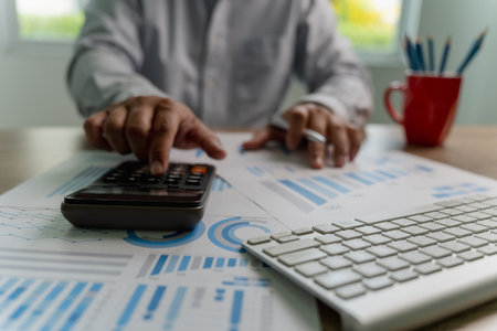 man using a calculator accountant working on desk budget and loan Close up Accounting analysis, tax finance, bank income savings budgetの写真素材