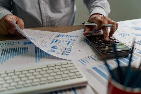 man using a calculator accountant working on desk budget and loan Close up Accounting analysis, tax finance, bank income savings budgetの写真素材