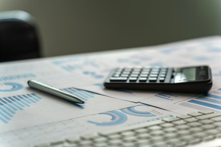 Close-up of the calculator paper data report Financial chart and pen document analysis budget chart finance accounting conceptの写真素材