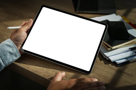 A businessman holds a mockup. digital tablet with blank screen Mockup replaces your design mockup in...