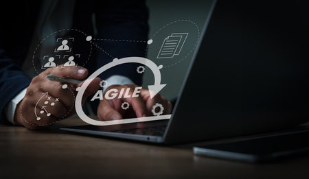 A businessman using a laptop computer Agile management and the principles of agile software developmentの写真素材