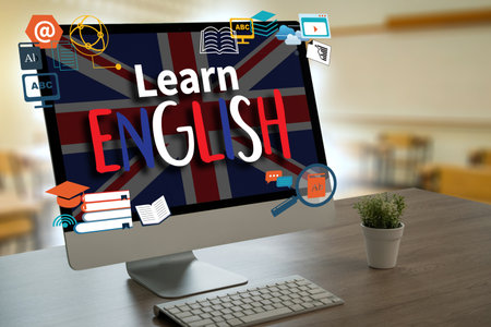 Learn English on the screen. man is typing on a laptop he is sitting at a desk . Concept of learning a new languageの写真素材