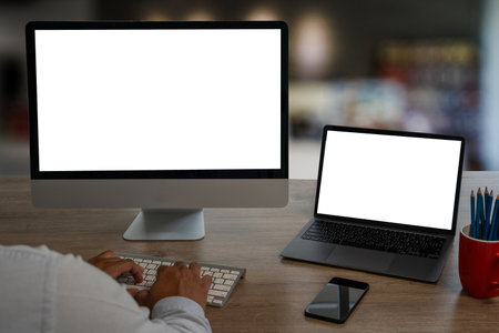 young man working using a desktop computer of the blank screenの写真素材