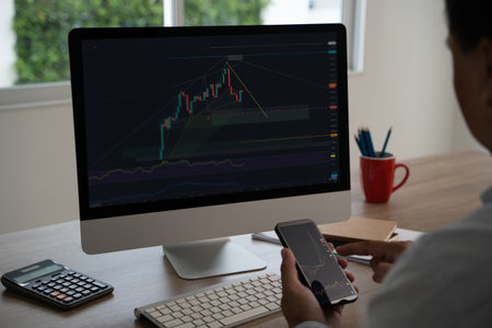 Businessman online trader using a computer and on phone with discussing dynamic stock market