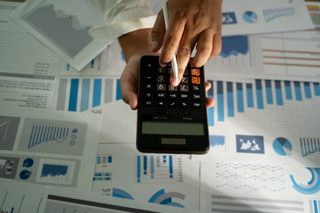 man hand using calculator finance budgeting and tax Financial cost calculation statistical data analysisの写真素材