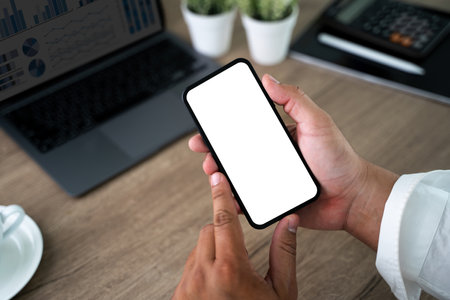 Top view Mockup image hand using a smartphone man Holding Cell Phone With Blank Screenの写真素材