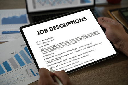 The businesswoman used her laptop to fill out the job application, reviewing the contract and qualifications for the new position in the company.の写真素材