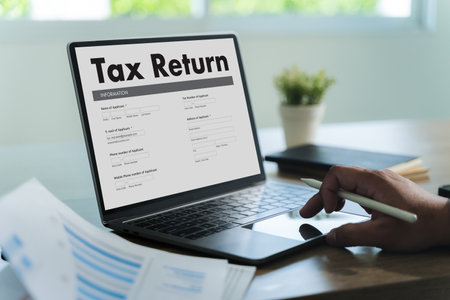 tax return  Business person using a laptop Tax season is approaching, and businesses must file their income return online to meet government deadlines, avoid debt, and ensure a refund.の写真素材