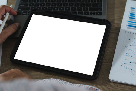 A businessman holds a mockup. iPad digital tablet with blank screen Mockup replaces your design mockup in the office.の写真素材