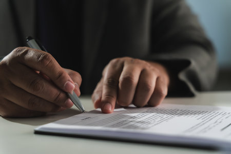 businesswoman signing document On Contract Paper reading and checking financial documents