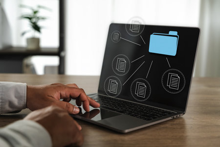 An office files report document person working laptop with digital file icons and folder graphic screen, indicating data management or organizationの写真素材