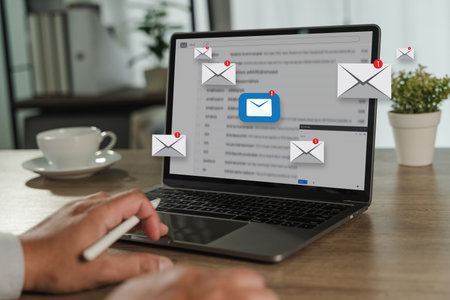 man reading e-mail on smartphone email inbox and email with laptop on internet information from spam mailの写真素材