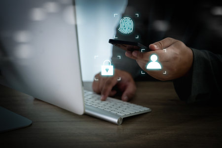 Cybersecurity and mobile authentication concept, businessman using smartphone with face ID,...