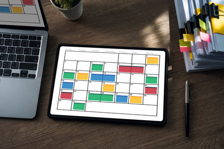 showing a monthly calendar with color coded time blocking on a wooden desk, ideal for planning...