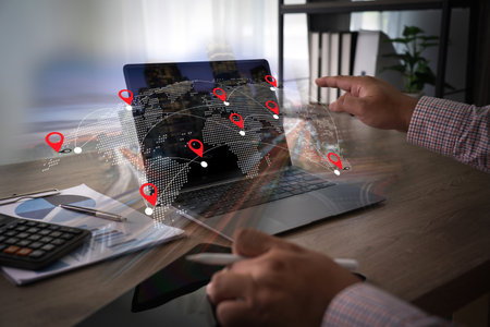 GPS tracking system real-time person interacts with digital map showing multiple location markers and route connections, indicating navigationの写真素材