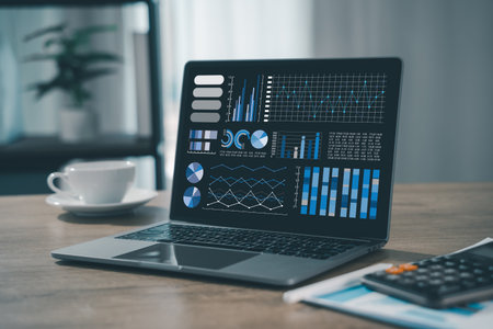 business analyst used a laptop to analyze financial statistics, creating a digital dashboard for...