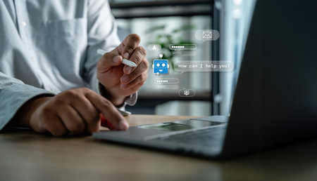 Businessman using AI chatbot interface on laptop for digital contact center support AI assistant interface on laptop providing information and intelligenceの写真素材