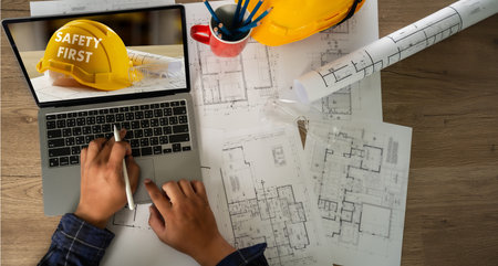 Site surveyor review design, helmet yellow placed near building where architect follow rule in...