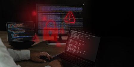 Spyware and cyber attack warning concept alert icons over code on laptop , representing malware...