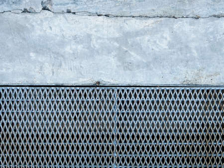 Steel grate of manhole cover duty drain on the concrete roadside.の写真素材