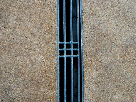 Steel grating of drains on concrete walkways