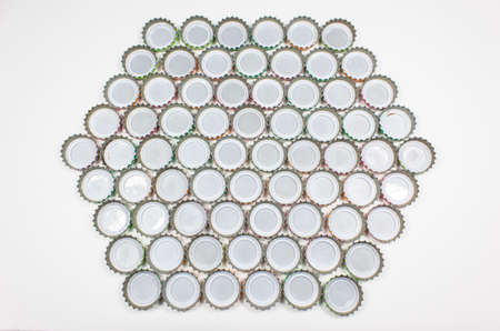 Soft drink bottle caps on white background
