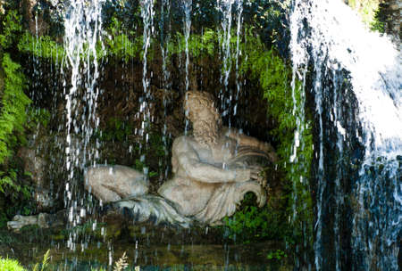 Statue behind Waterfallの写真素材