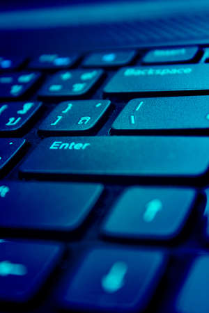 Computer keyboard in blue light 