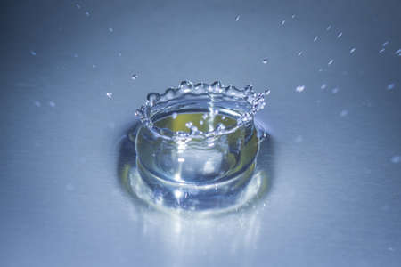 Close up abstract water drops splash on blue backgroundの写真素材
