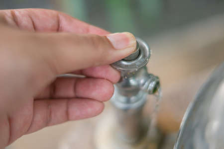 men's hand opening water tapの写真素材