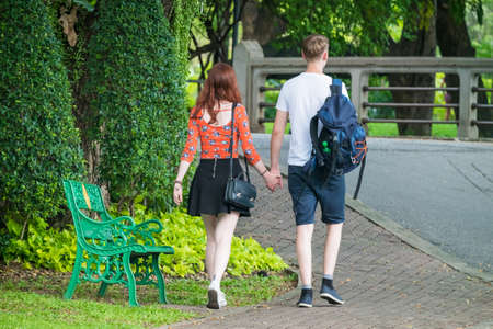 Couple Holding Hands Walking Awayの写真素材