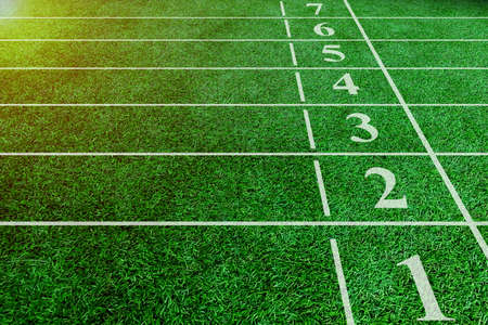 Numbers starting point on green running track, running track at the stadium