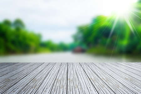Empty wood table over blurred green natureの写真素材