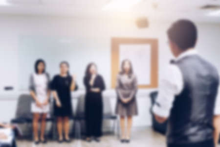 Blurred view of people at business training