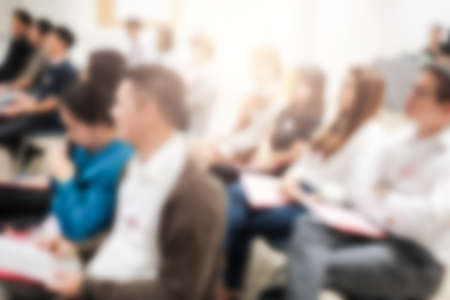 Abstract blurred photo of conference hall or seminar room with attendee backgroundの写真素材