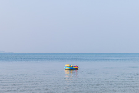 Rubber chair floating on the seaの写真素材
