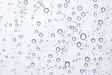 sky view through car window with rain dropsの写真素材