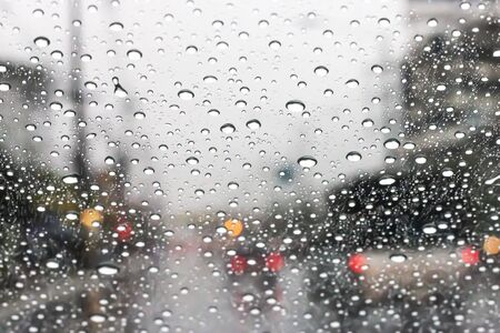 The windshield has rain water on the road when driving on the city streetsの写真素材