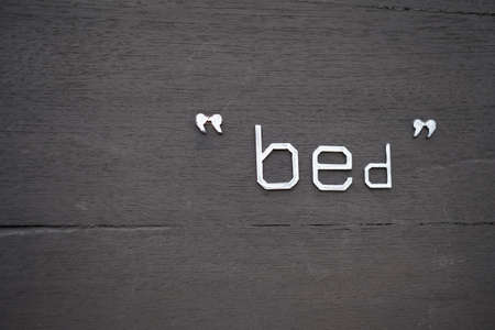 Dark background wood texture and word bed.の写真素材