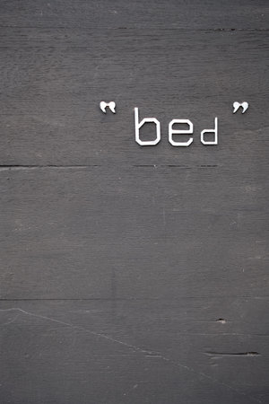 Dark background wood texture and word bed. verticleの写真素材