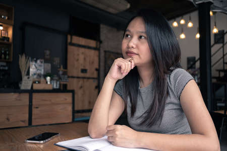 Asia woman thinking in coffee shop. Idea Conceptの写真素材