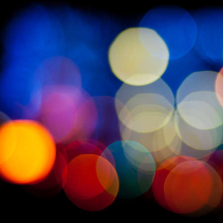 Bokeh sparkling lights background. Blurred defocused lights of city at night. Christmas blurred lights background. Abstract colorful background.の写真素材