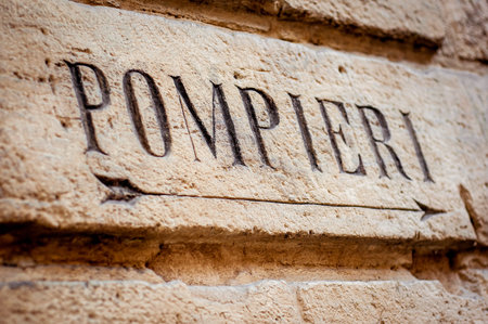 Fire station sign direction. Old stone sign. Italian word.の写真素材