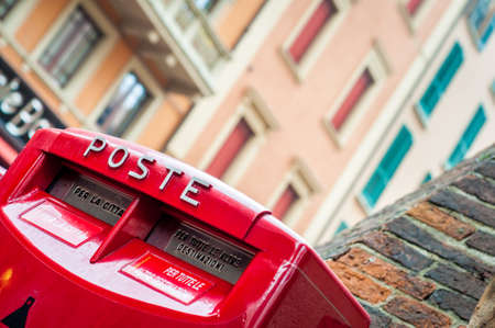 Red letter box. Italian mail service box. Traveling. City street view Italy.の写真素材