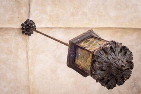 Old street lamp hanging from ceiling. Ornate lantern.の写真素材